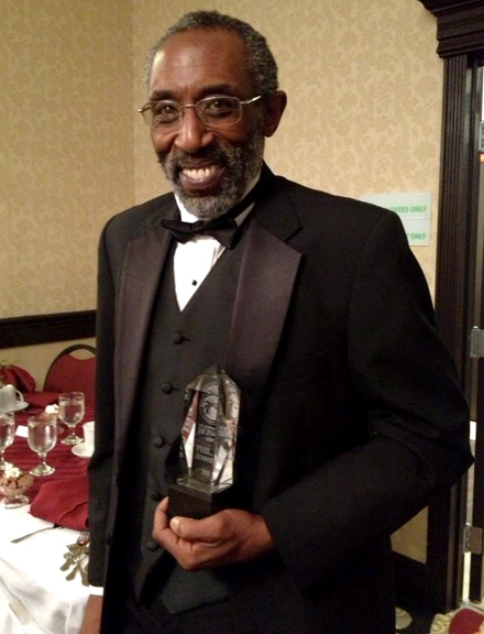 Photo of Sifu Phil Jennings holding his award.